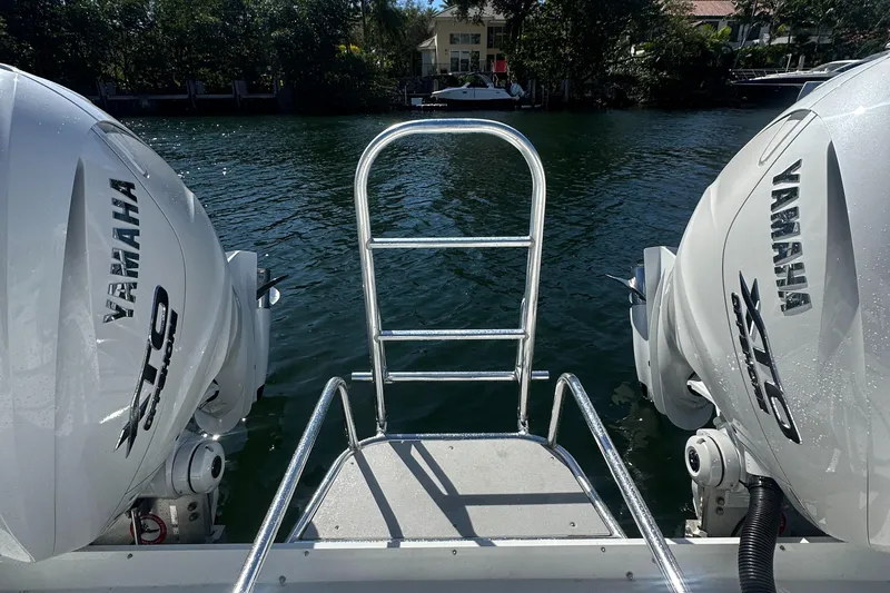  Yacht Photos Pics AmeraCat 395 boat with dual Yamaha engines, rear view, docked on a serene waterway.