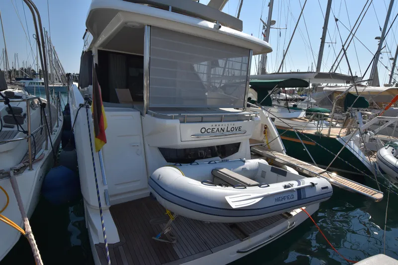 Ocean Love Yacht Photos Pics 2023 Absolute 50 Fly yacht docked with inflatable boat on deck.