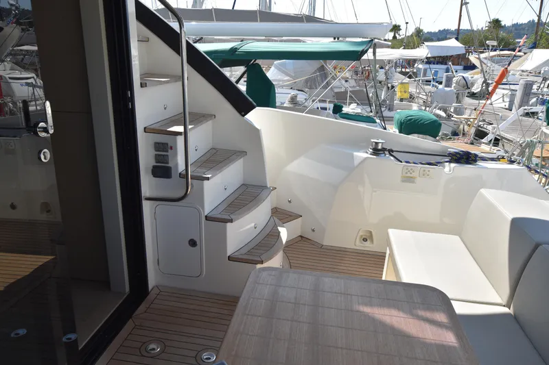 Ocean Love Yacht Photos Pics Luxurious 2023 Absolute 50 Fly yacht interior with elegant staircase and seating area.