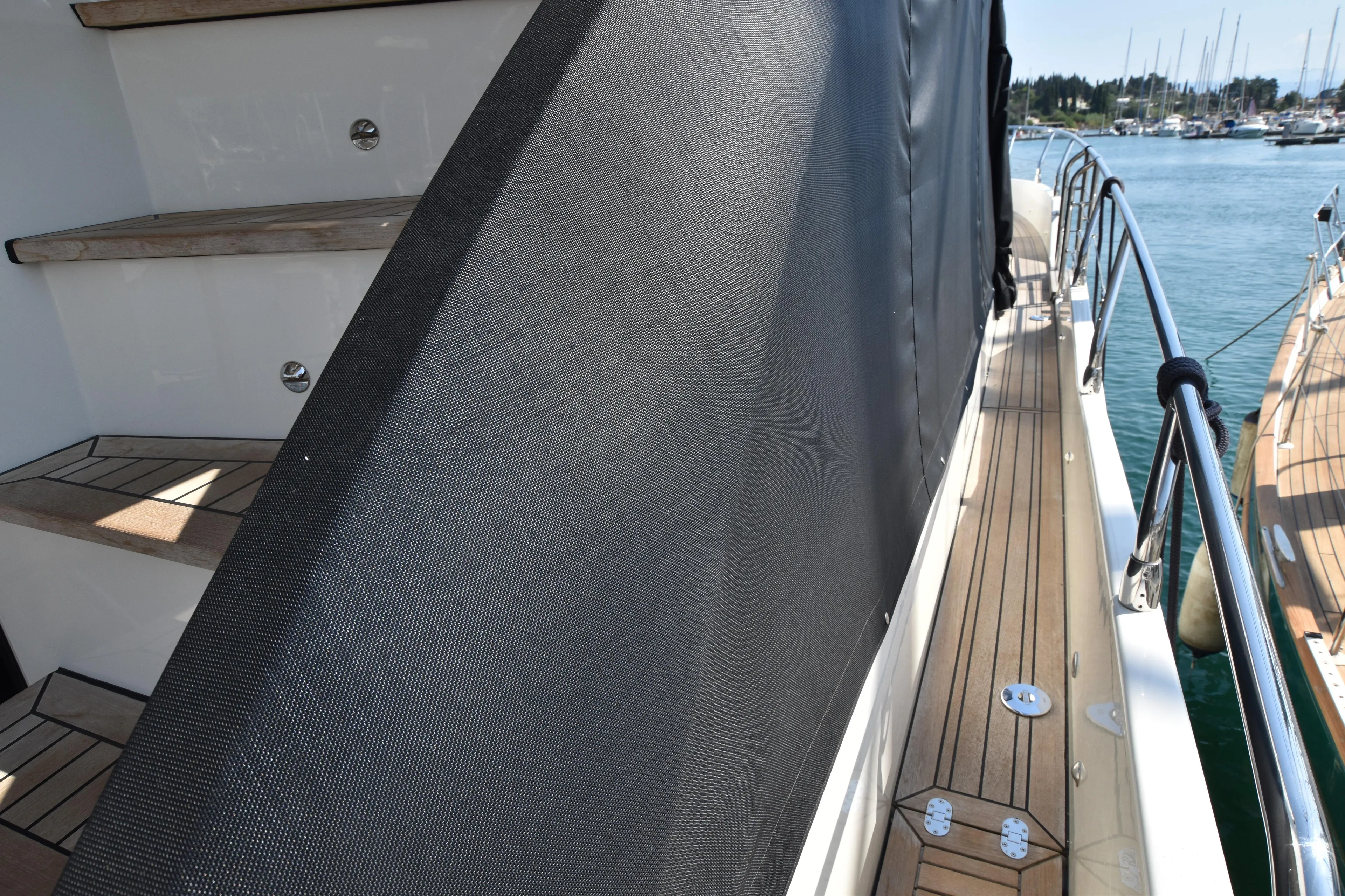 Ocean Love Yacht Photos Pics 2023 Absolute 50 Fly yacht deck with wooden steps and railing.