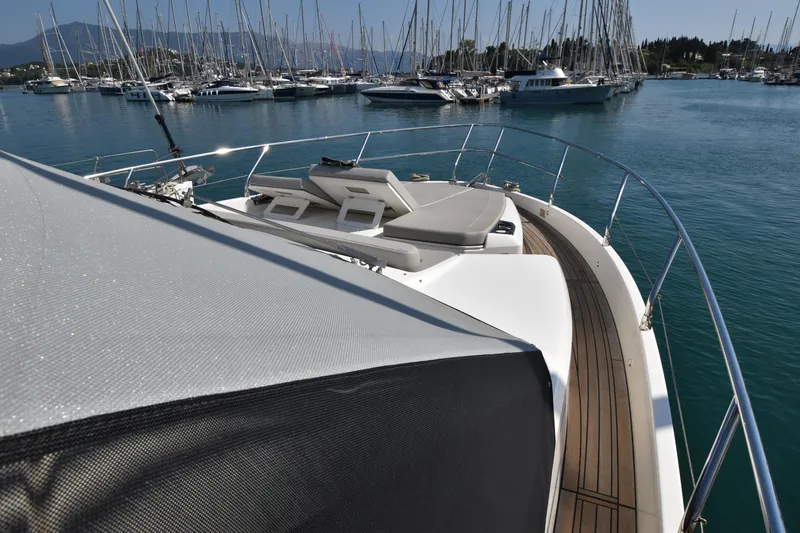 Ocean Love Yacht Photos Pics 2023 Absolute 50 Fly yacht deck with sun loungers, docked in a marina.