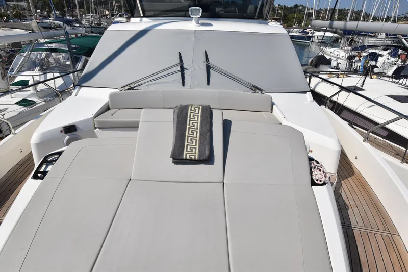 Ocean Love Yacht Photos Pics 2023 Absolute 50 Fly yacht with sunbathing area, docked in marina.