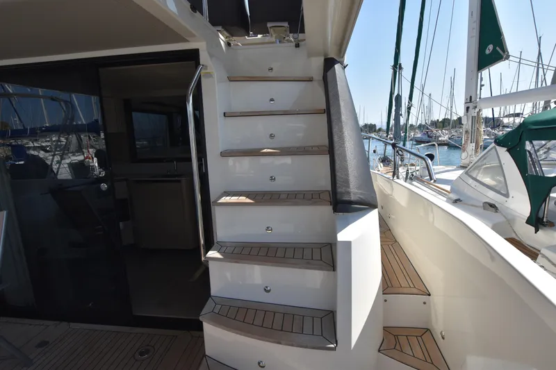 Ocean Love Yacht Photos Pics Staircase on 2023 Absolute 50 Fly yacht, leading to upper deck with marina view.