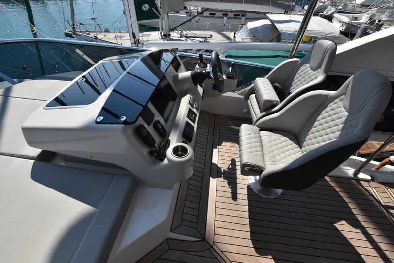 Ocean Love Yacht Photos Pics Luxurious helm of 2023 Absolute 50 Fly yacht with modern controls and plush seating.