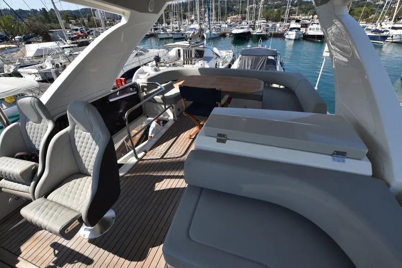 Ocean Love Yacht Photos Pics Luxurious 2023 Absolute 50 Fly yacht interior with elegant seating and marina view.