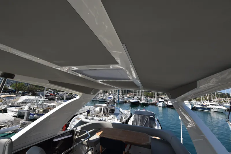 Ocean Love Yacht Photos Pics 2023 Absolute 50 Fly yacht interior with marina view, showcasing sleek design and luxury.