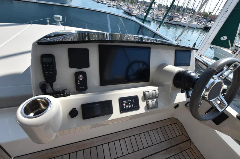 Ocean Love Yacht Photos Pics Cockpit of 2023 Absolute 50 Fly yacht with modern controls and steering wheel.