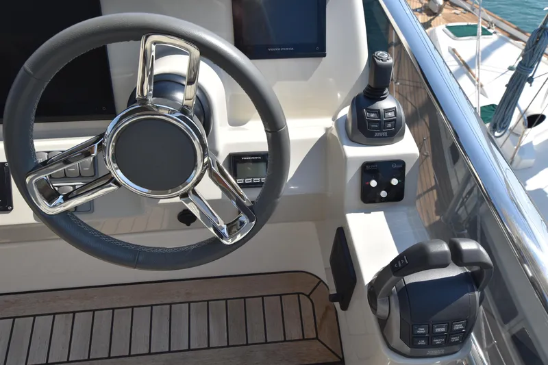Ocean Love Yacht Photos Pics Helm of 2023 Absolute 50 Fly yacht with steering wheel and controls.