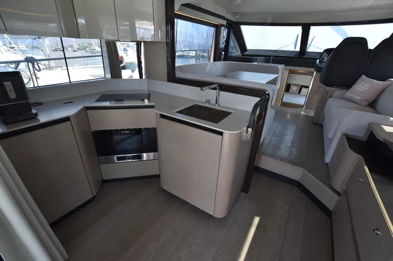 Ocean Love Yacht Photos Pics Modern kitchen interior of 2023 Absolute 50 Fly yacht with sleek design and appliances.