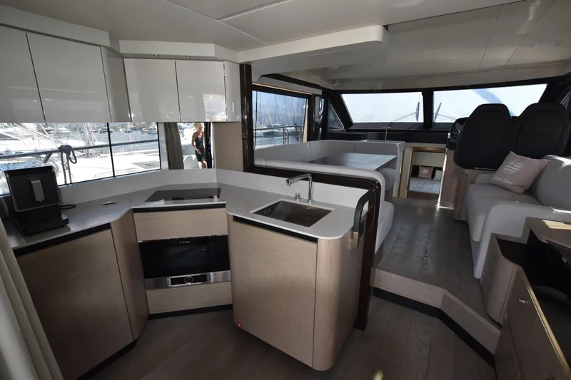 Ocean Love Yacht Photos Pics Luxurious interior of 2023 Absolute 50 Fly yacht with modern kitchen and seating area.