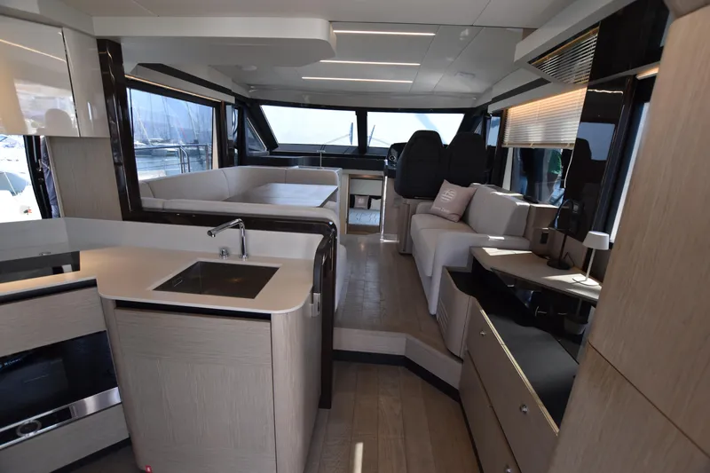 Ocean Love Yacht Photos Pics Luxurious interior of 2023 Absolute 50 Fly yacht with modern kitchen and seating area.