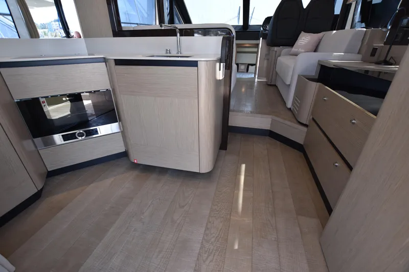 Ocean Love Yacht Photos Pics Interior of 2023 Absolute 50 Fly yacht featuring modern kitchen and seating area.