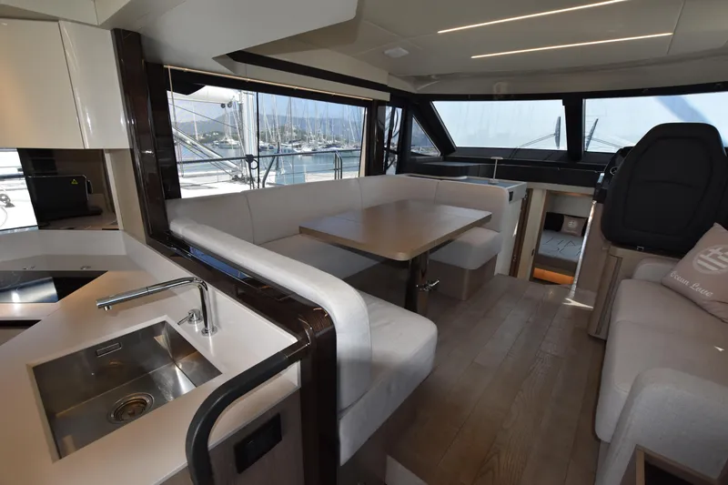 Ocean Love Yacht Photos Pics Luxurious interior of 2023 Absolute 50 Fly yacht with modern kitchen and seating area.