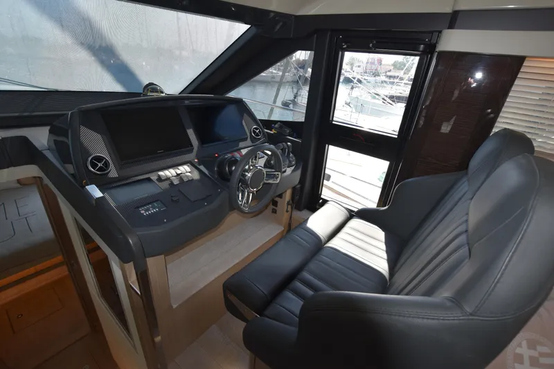 Ocean Love Yacht Photos Pics Cockpit of 2023 Absolute 50 Fly yacht with modern controls and leather seating.