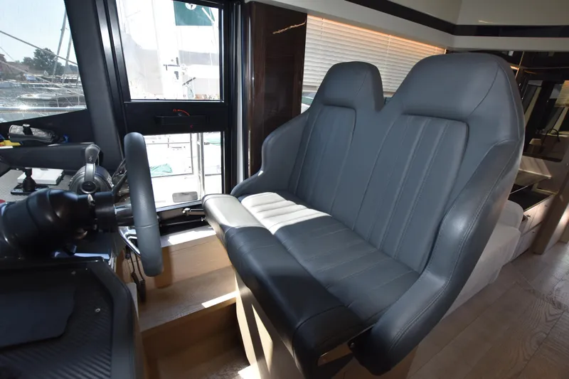 Ocean Love Yacht Photos Pics Interior helm seating of 2023 Absolute 50 Fly yacht, featuring modern design and leather upholstery.