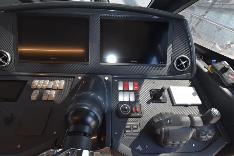 Ocean Love Yacht Photos Pics Cockpit of 2023 Absolute 50 Fly yacht with dual screens and control panel.