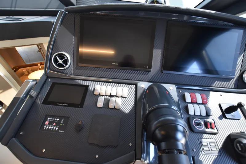Ocean Love Yacht Photos Pics Control panel of 2023 Absolute 50 Fly yacht with dual screens and navigation controls.