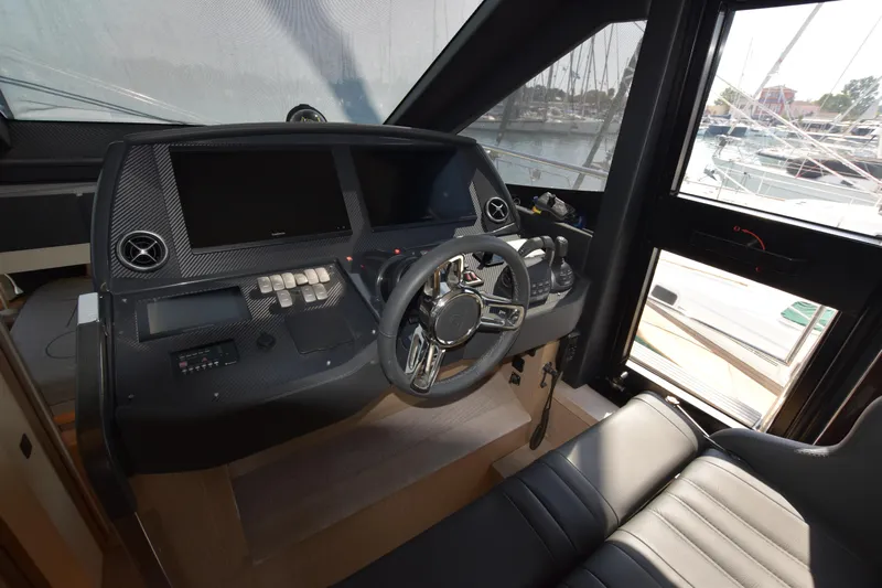 Ocean Love Yacht Photos Pics 2023 Absolute 50 Fly yacht helm with modern controls and sleek design.