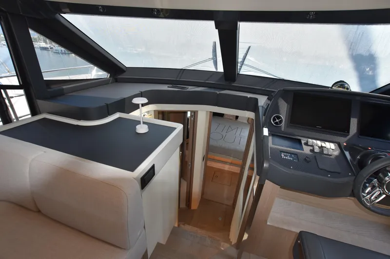 Ocean Love Yacht Photos Pics Interior view of 2023 Absolute 50 Fly yacht cockpit with modern controls and seating.