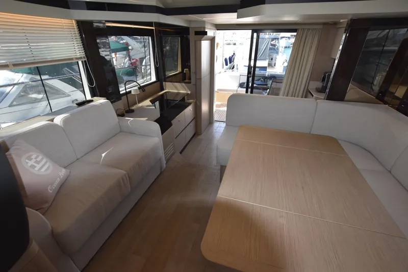 Ocean Love Yacht Photos Pics Luxurious interior of 2023 Absolute 50 Fly yacht with modern seating and dining area.