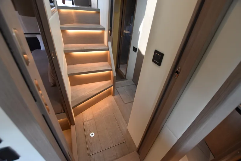 Ocean Love Yacht Photos Pics Interior of 2023 Absolute 50 Fly yacht with illuminated wooden stairs.