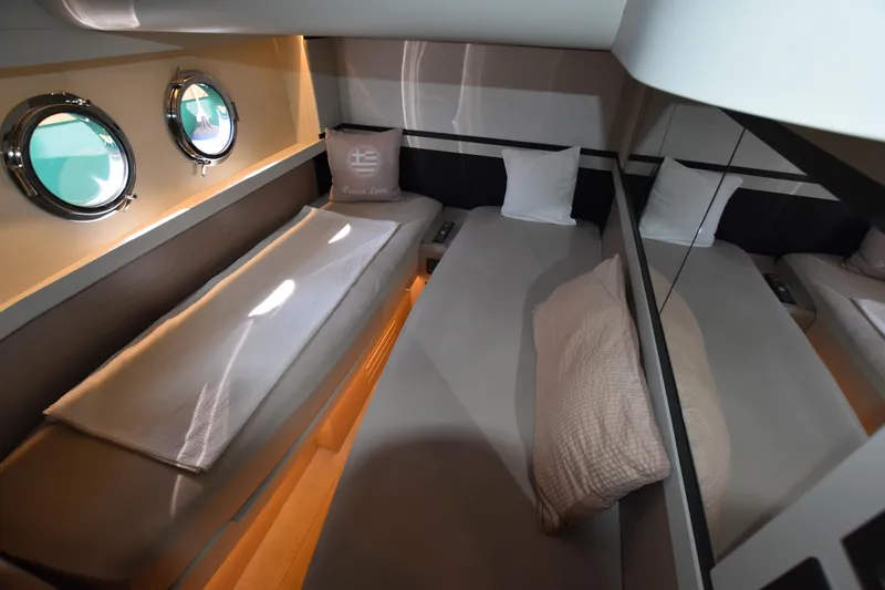 Ocean Love Yacht Photos Pics Luxurious cabin interior of 2023 Absolute 50 Fly yacht with twin beds and porthole windows.