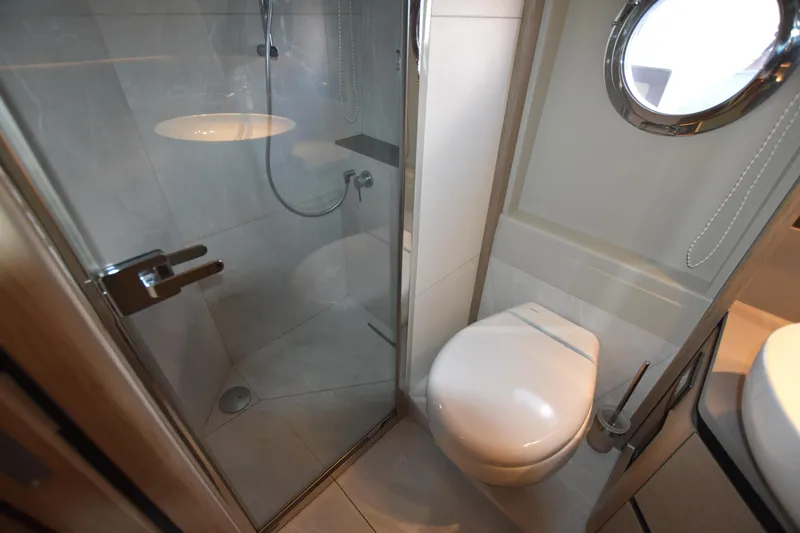 Ocean Love Yacht Photos Pics Modern bathroom on 2023 Absolute 50 Fly yacht with shower and porthole.
