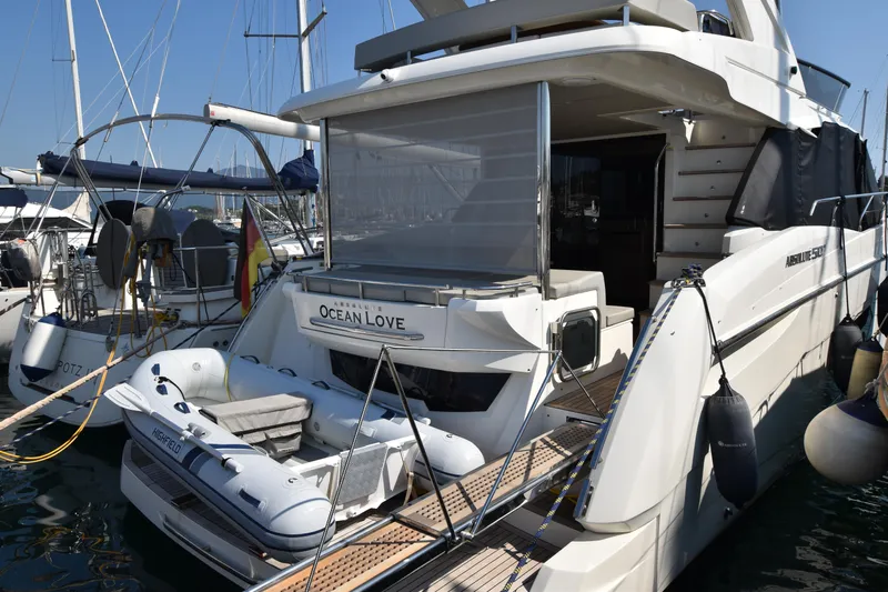Ocean Love Yacht Photos Pics Luxury yacht Absolute 50 Fly 2023 docked with inflatable boat and marina view.