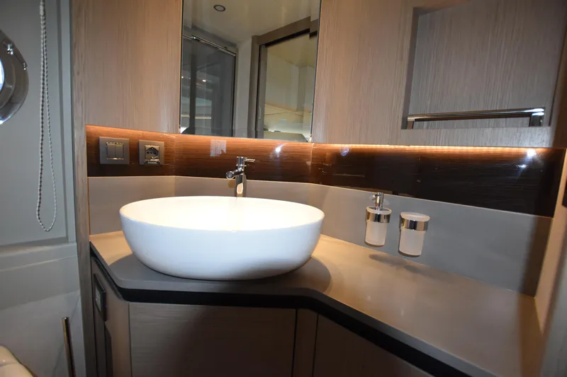 Ocean Love Yacht Photos Pics Luxurious bathroom interior of 2023 Absolute 50 Fly yacht with modern sink and lighting.