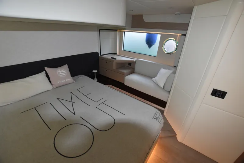 Ocean Love Yacht Photos Pics Luxurious bedroom interior of 2023 Absolute 50 Fly yacht with modern design and cozy seating.