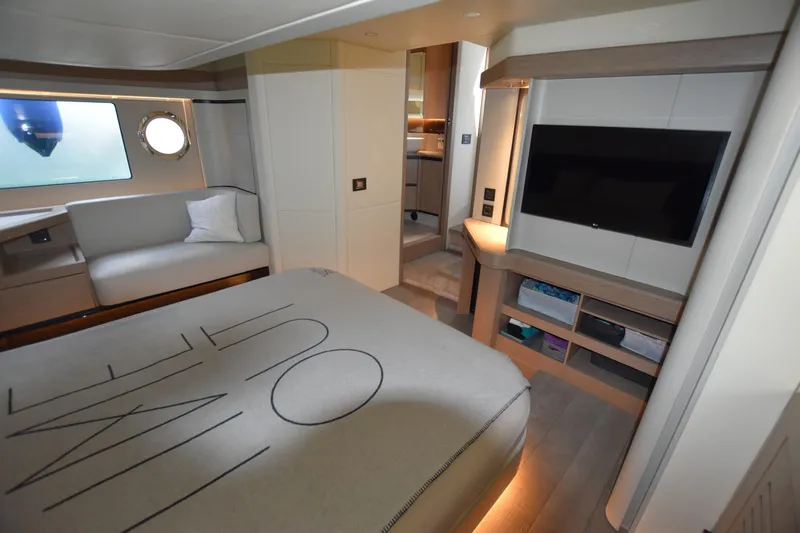 Ocean Love Yacht Photos Pics Luxurious interior of 2023 Absolute 50 Fly yacht with modern furnishings and large TV.