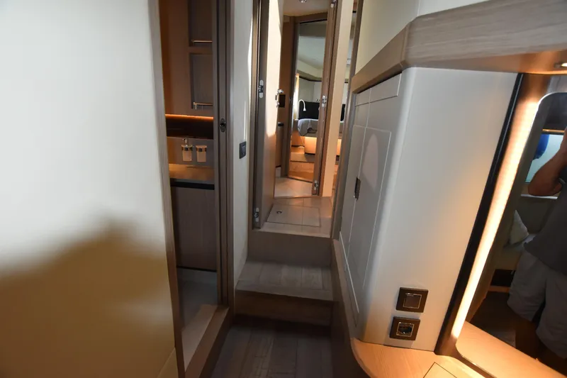 Ocean Love Yacht Photos Pics Interior hallway of 2023 Absolute 50 Fly yacht, featuring modern design and ambient lighting.