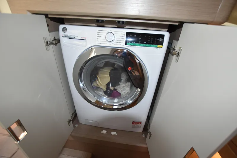 Ocean Love Yacht Photos Pics Washing machine inside a cabinet on the Absolute 50 Fly yacht, 2023 model.