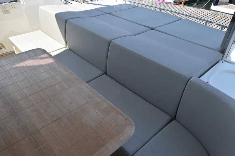 Ocean Love Yacht Photos Pics Luxurious seating area on 2023 Absolute 50 Fly yacht with wooden table.