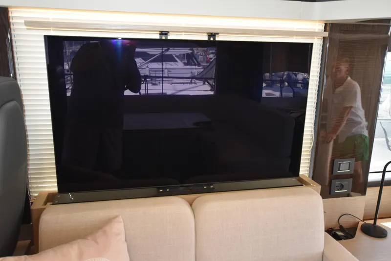 Ocean Love Yacht Photos Pics Luxurious interior of 2023 Absolute 50 Fly yacht with modern TV setup.