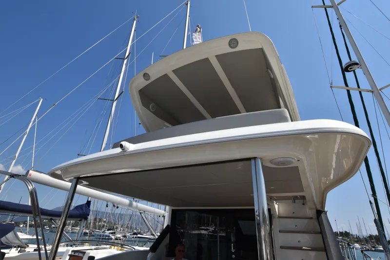 Ocean Love Yacht Photos Pics 2023 Absolute 50 Fly yacht docked in a marina under clear blue skies.