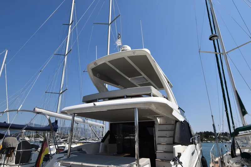 Ocean Love Yacht Photos Pics 2023 Absolute 50 Fly yacht docked at marina under clear blue sky.