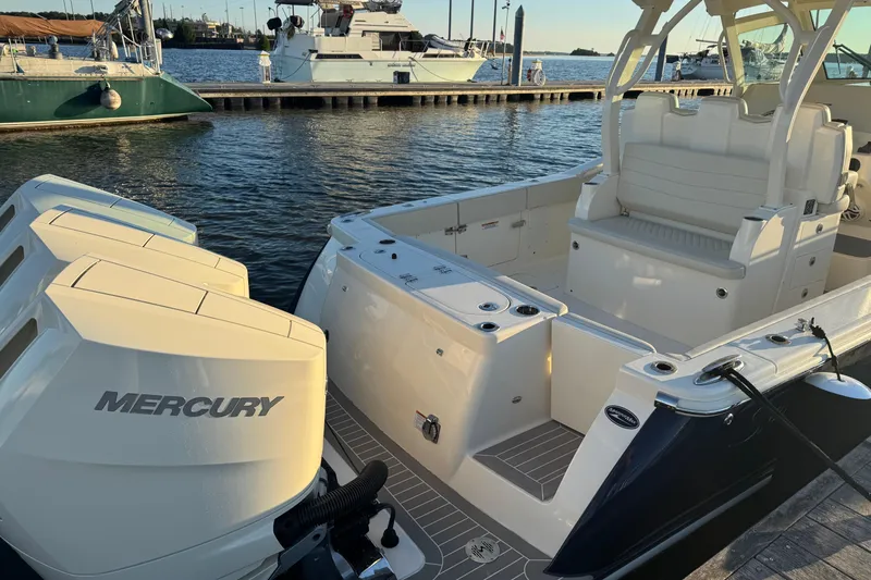  Yacht Photos Pics 2025 Scout 357 LXF boat with Mercury engines docked at marina.