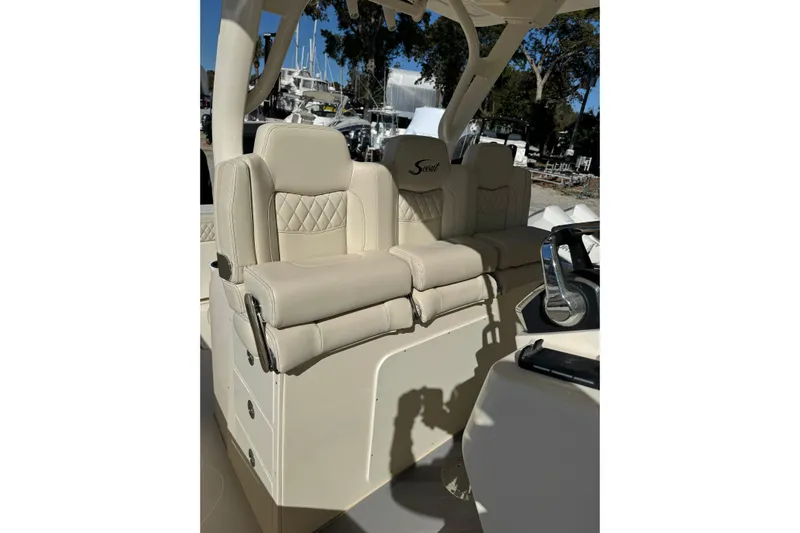  Yacht Photos Pics 2025 Scout 357 LXF boat with luxurious beige seating and steering console.