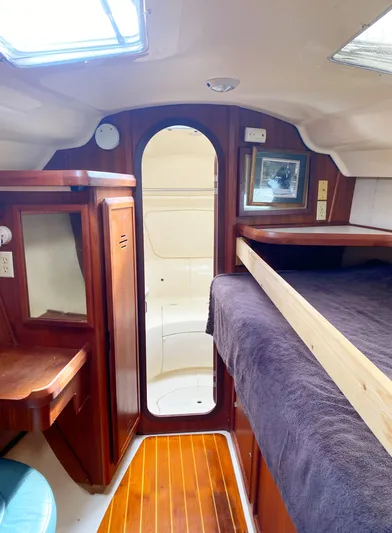 5th Row Center Yacht Photos Pics Interior of 1997 Hunter 430 sailboat with wood finish and cozy sleeping area.