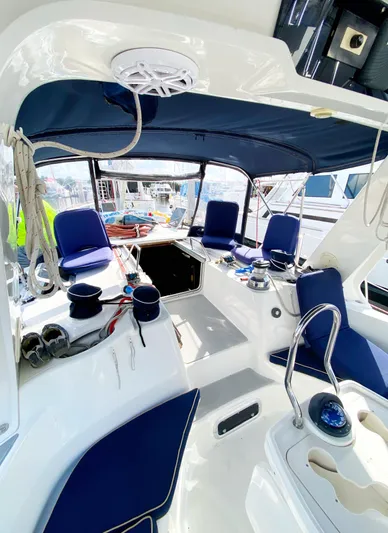 5th Row Center Yacht Photos Pics 1997 Hunter 430 sailboat cockpit with blue seating and canopy, featuring modern navigation equipment.