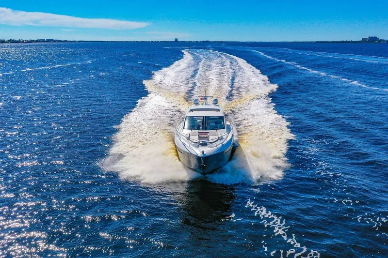  Yacht Photos Pics 2020 Cruisers Yachts 50 Cantius cruising on open water under clear blue skies.