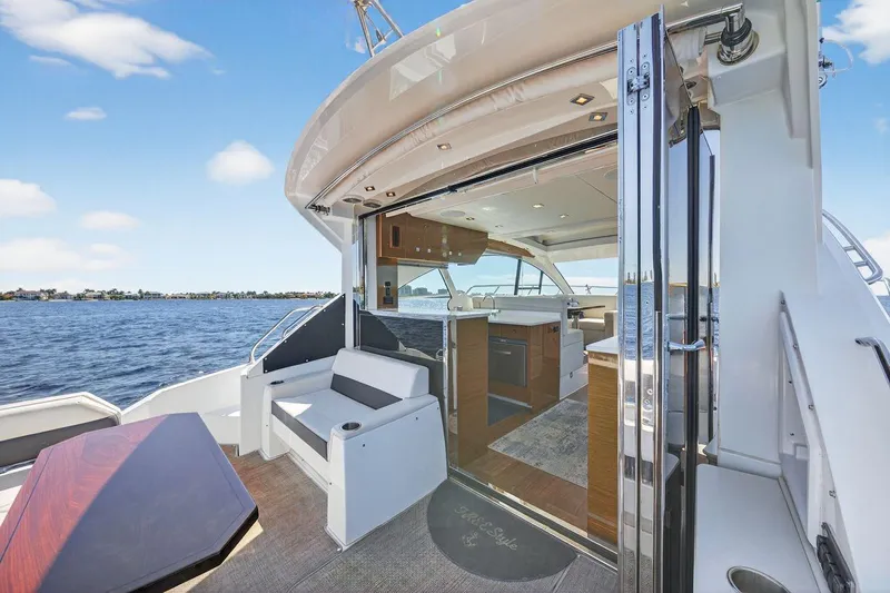  Yacht Photos Pics 2020 Cruisers Yachts 50 Cantius, luxurious interior with open deck, overlooking serene waters.