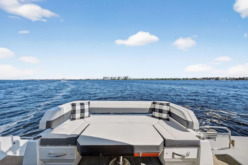  Yacht Photos Pics 2020 Cruisers Yachts 50 Cantius, rear seating view, open water, clear sky.