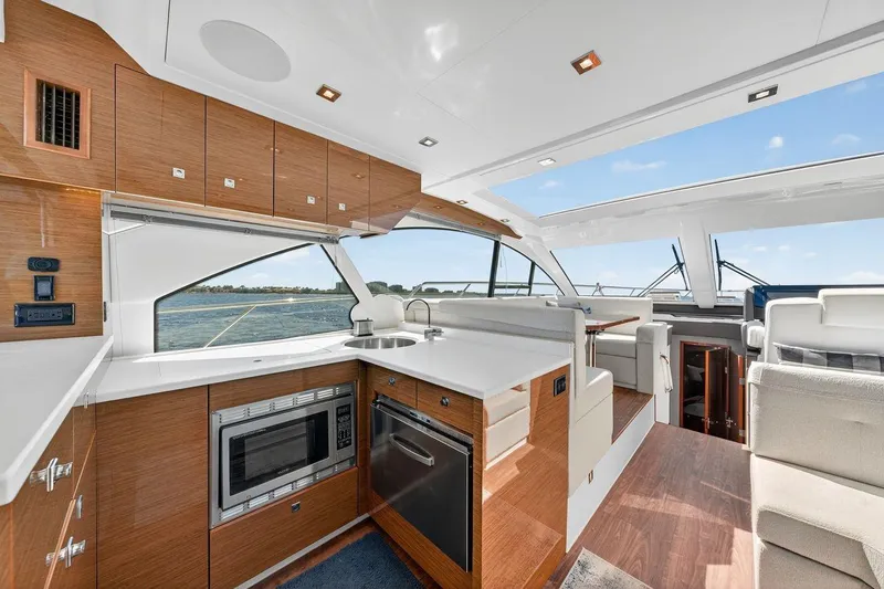  Yacht Photos Pics Luxurious interior of 2020 Cruisers Yachts 50 Cantius with modern kitchen and seating area.