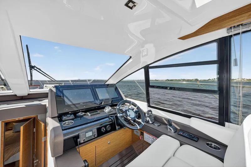  Yacht Photos Pics 2020 Cruisers Yachts 50 Cantius helm with modern controls and panoramic water view.
