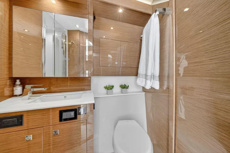  Yacht Photos Pics Luxurious bathroom in 2020 Cruisers Yachts 50 Cantius, featuring modern fixtures and elegant wood finishes.