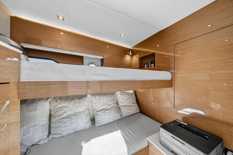  Yacht Photos Pics Luxurious 2020 Cruisers Yachts 50 Cantius cabin with modern wood finish and cozy bedding.
