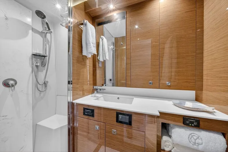 Yacht Photos Pics Luxurious bathroom in 2020 Cruisers Yachts 50 Cantius with modern fixtures and wood accents.