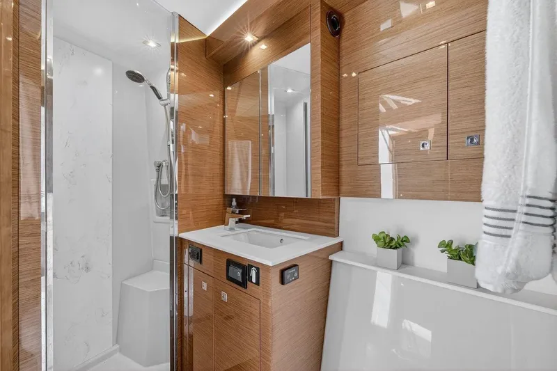  Yacht Photos Pics Luxurious bathroom in 2020 Cruisers Yachts 50 Cantius, featuring modern fixtures and elegant wood finishes.